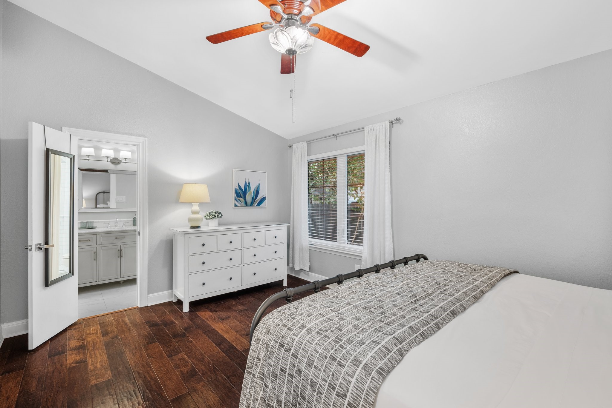 7601 Dallas Drive Austin, TX 78729 - Photo 12 of 20 a bedroom with a bed and a dresser