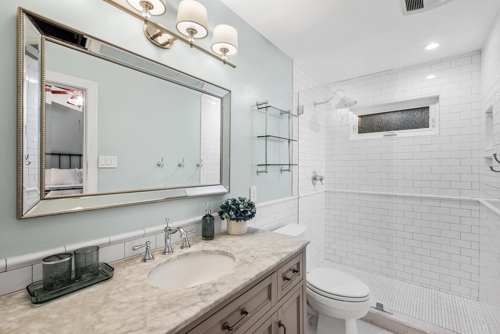 7601 Dallas Drive Austin, TX 78729 - Photo 13 of 20 a bathroom with a granite countertop sink a toilet and a mirror