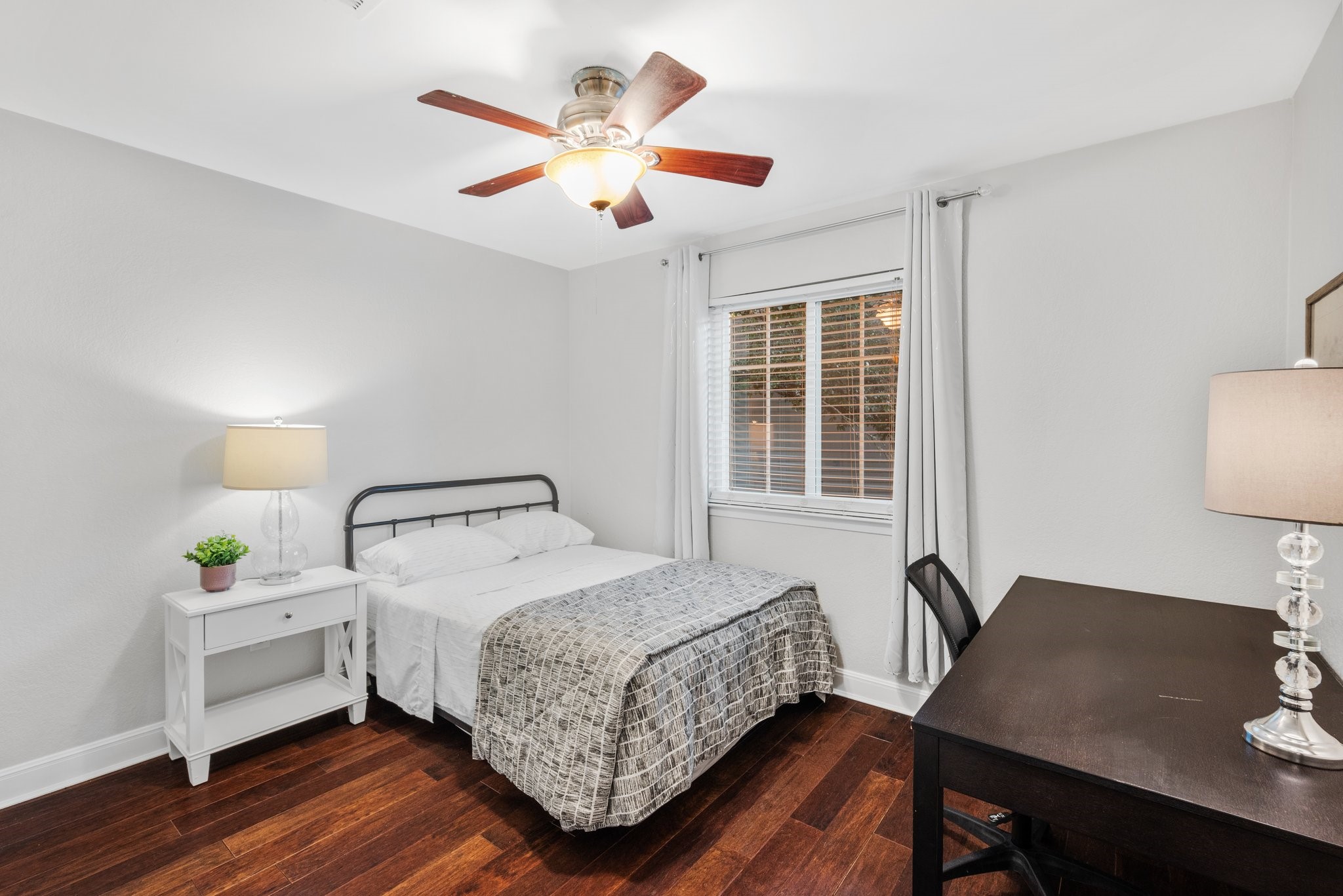 7601 Dallas Drive Austin, TX 78729 - Photo 17 of 20 a bedroom that has a bed and a table in it