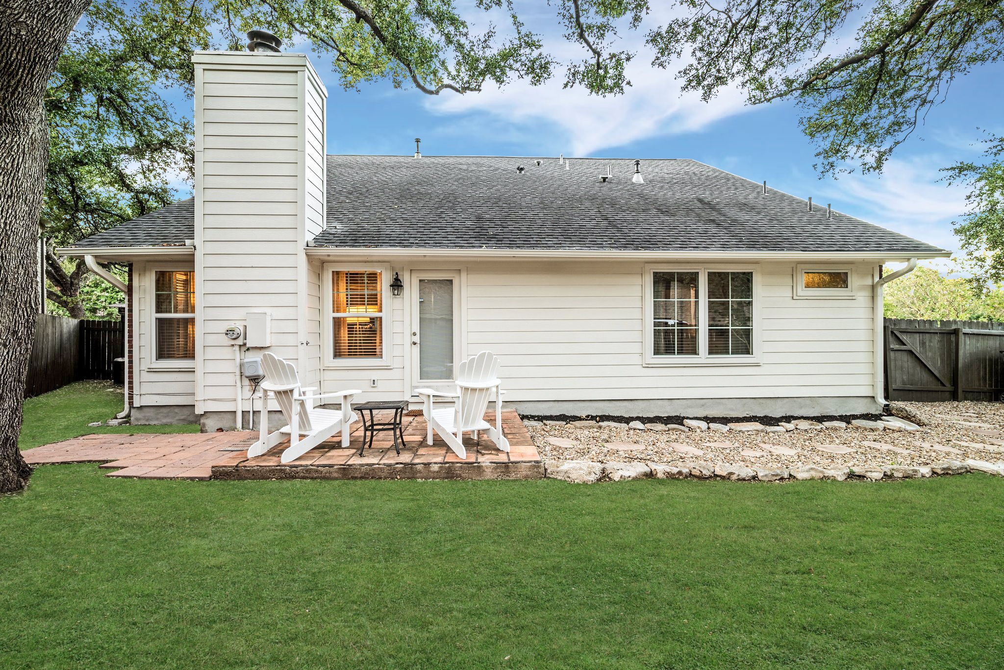 7601 Dallas Drive Austin, TX 78729 - Photo 19 of 20 a backyard of a house with table and chairs