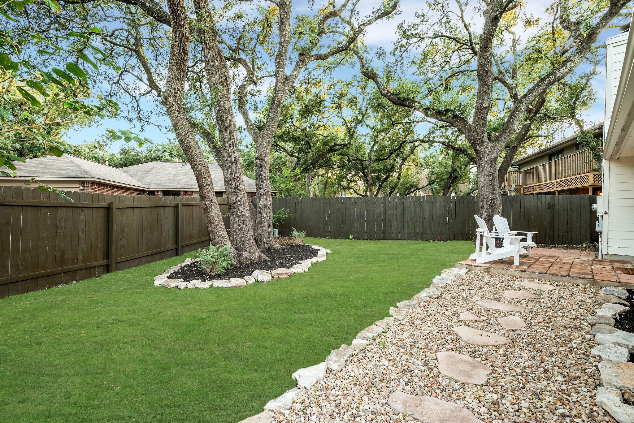 7601 Dallas Drive Austin, TX 78729 - Photo 20 of 20 a backyard of a house with table and chairs