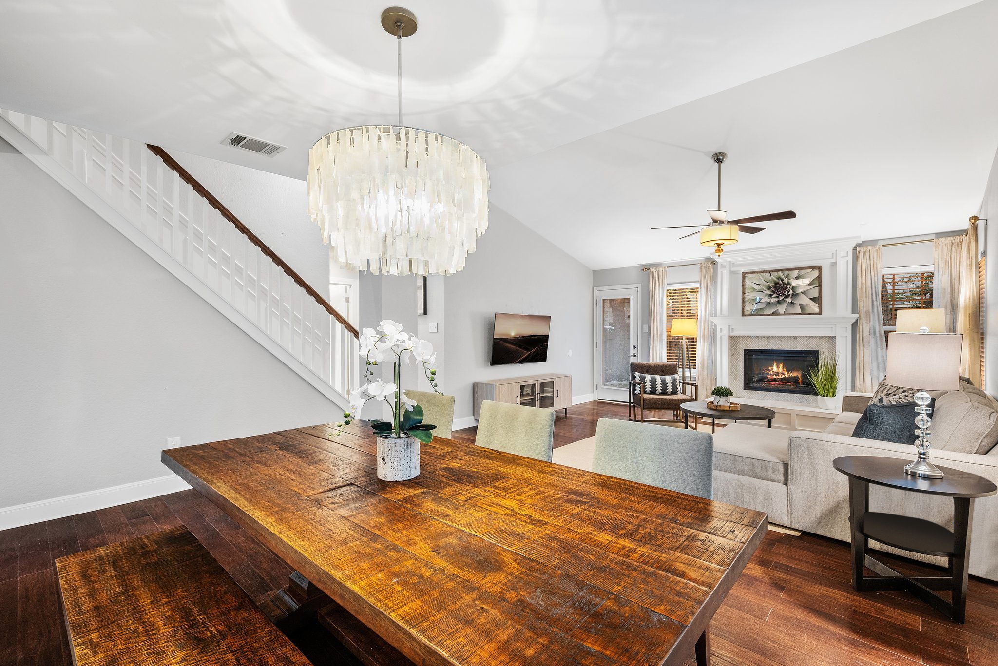 7601 Dallas Drive Austin, TX 78729 - Photo 6 of 20 a living room with fireplace furniture dining table and a chandelier