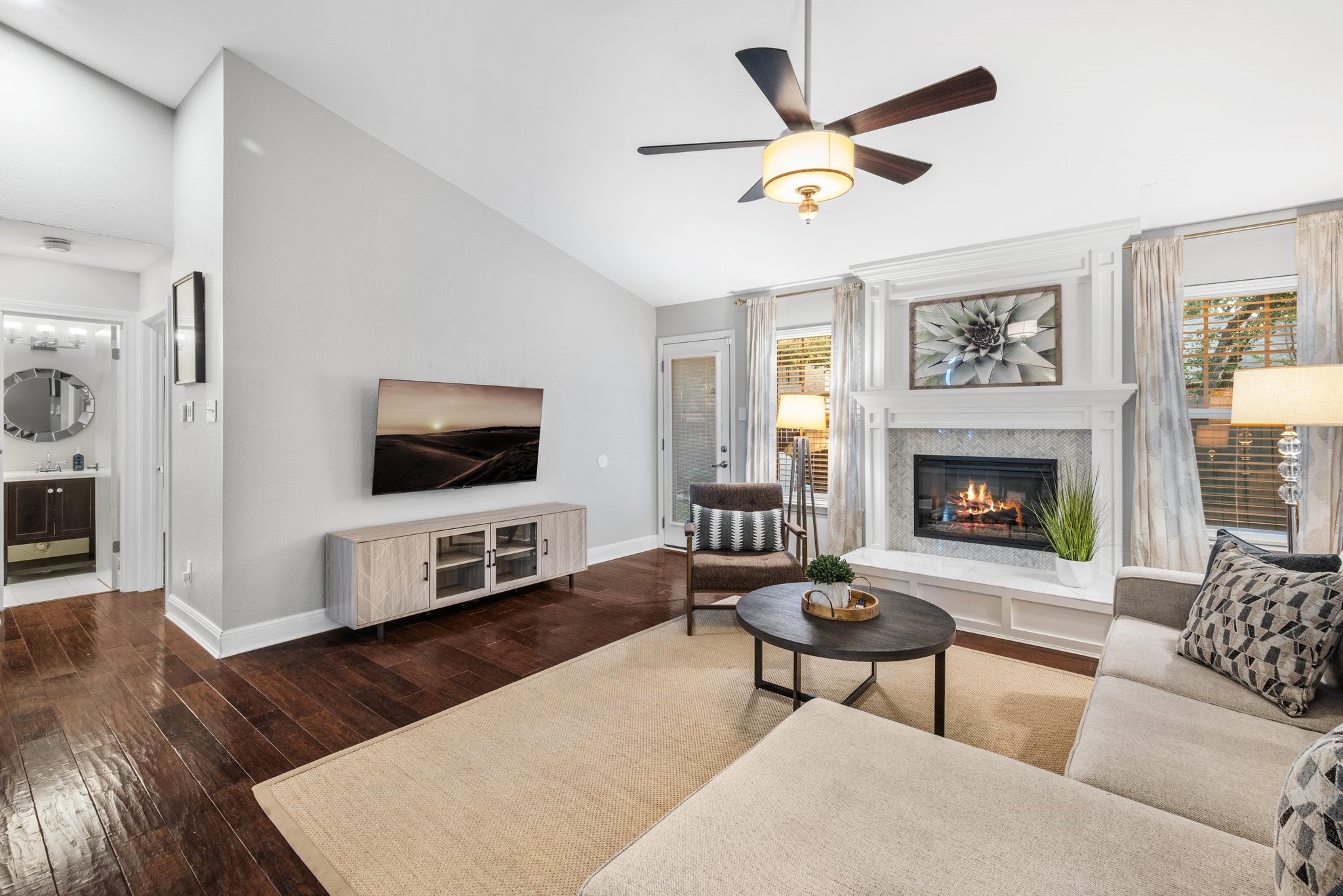 7601 Dallas Drive Austin, TX 78729 - Photo 9 of 20 a living room with furniture a flat screen tv and a fireplace
