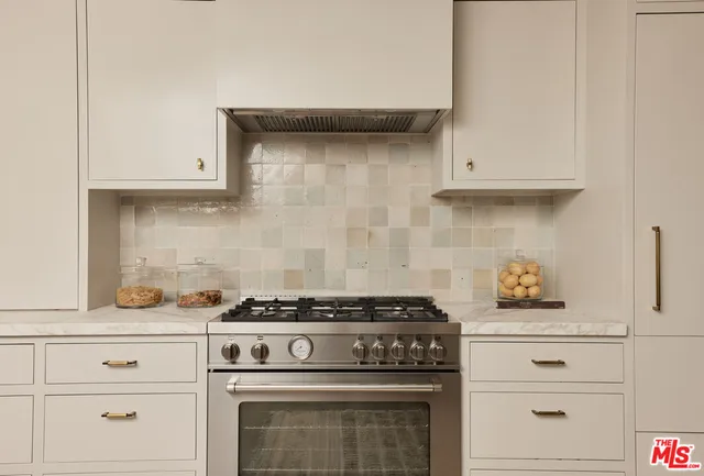 a stove top oven sitting inside of a kitchen
