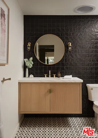 a bathroom with a sink mirror vanity and toilet