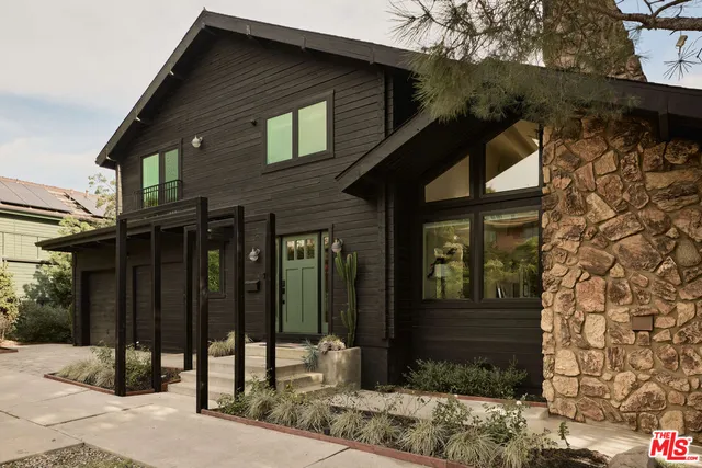 a view of a house with a door and wooden fence