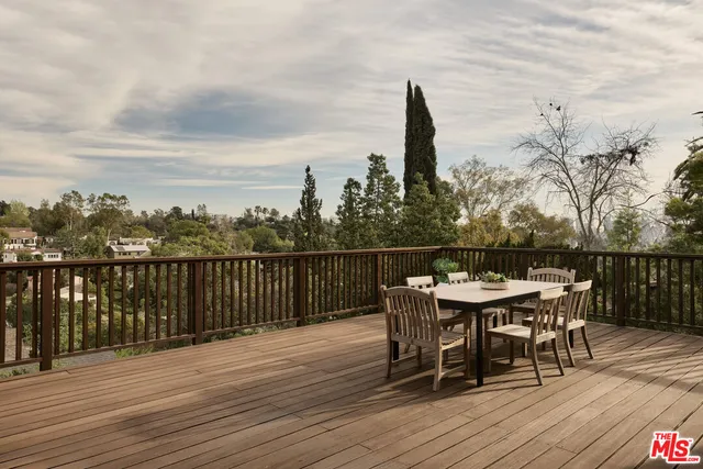 a roof deck with table and chairs