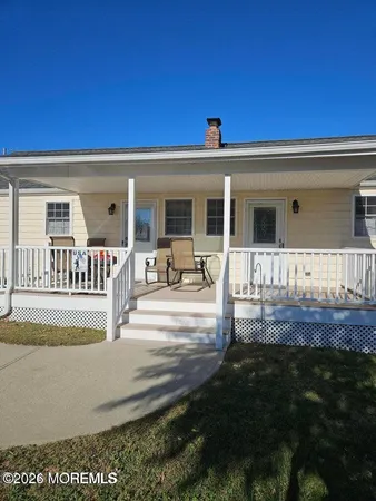 a view of a house with backyard and porch
