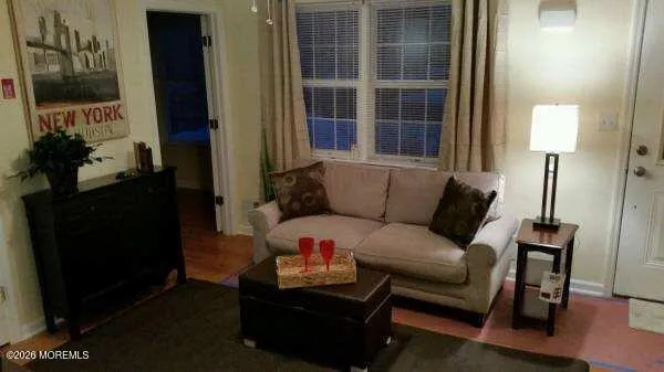 a living room with furniture and a lamp