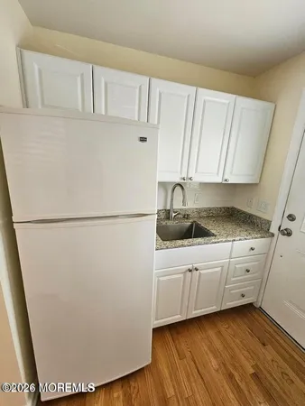 a kitchen with cabinets and white appliances