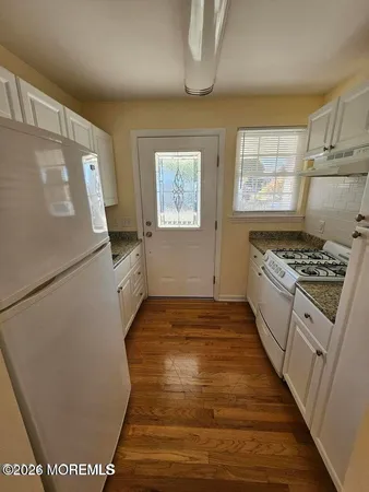 a kitchen with a refrigerator and a stove