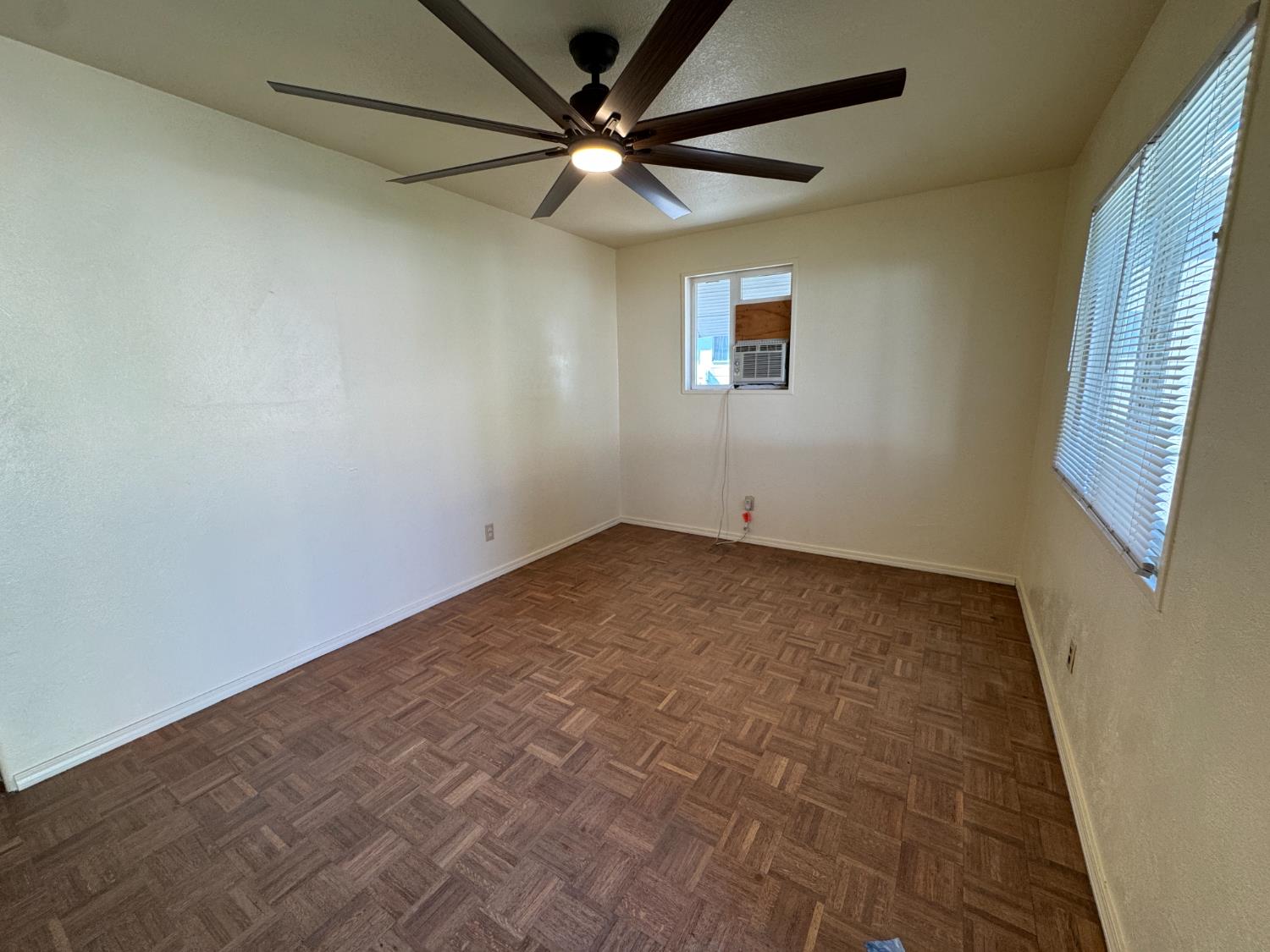 612 Union Street Isleton, CA 95641 - Photo 4 of 19 an empty room with a window and a fan