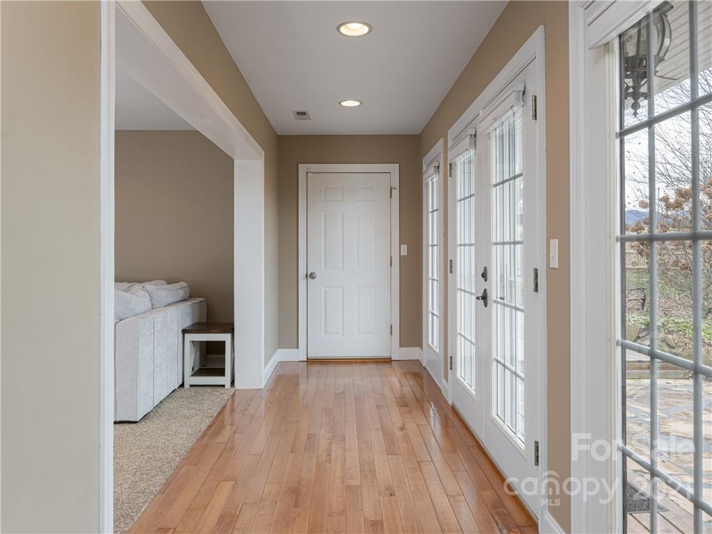 333 Gouges Branch Road Leicester, NC 28748 - Photo 12 of 48 a view of a hallway with wooden floor and a bathroom
