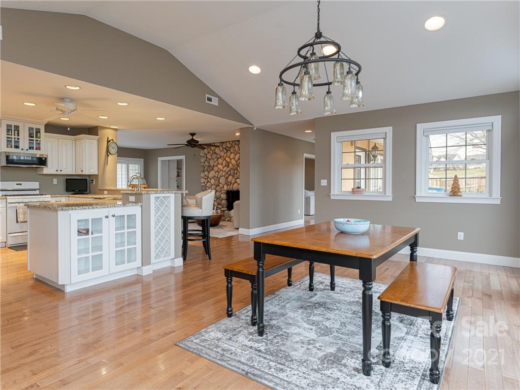 333 Gouges Branch Road Leicester, NC 28748 - Photo 15 of 48 a living room with stainless steel appliances kitchen island granite countertop furniture rug and wooden floor
