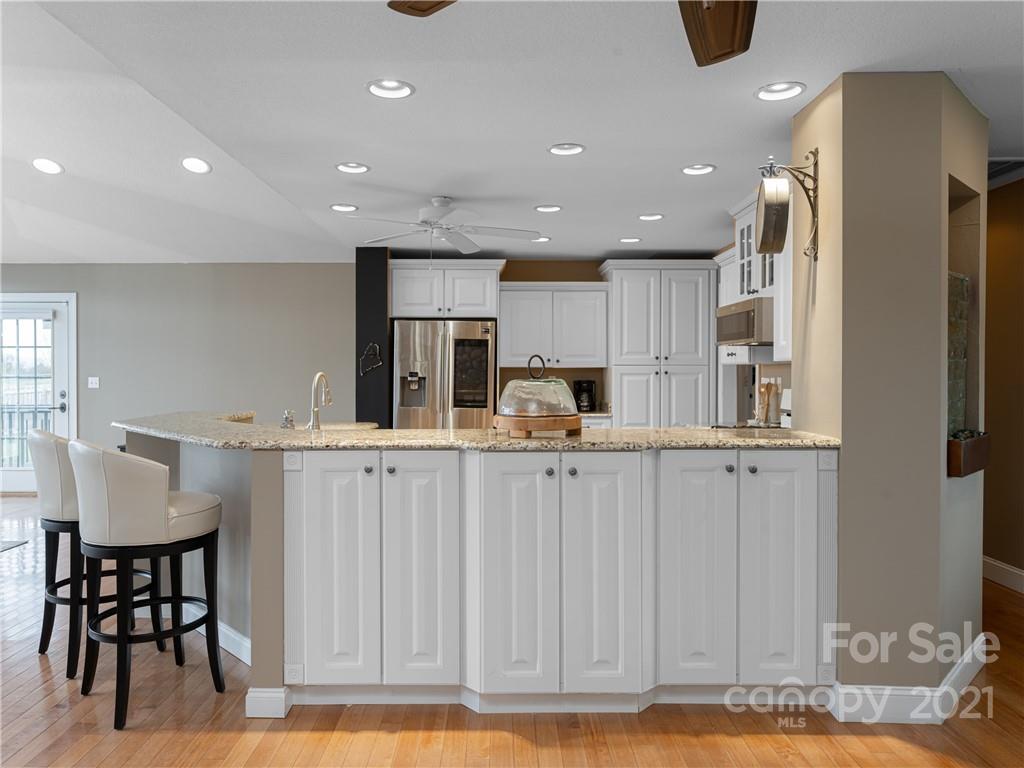 333 Gouges Branch Road Leicester, NC 28748 - Photo 17 of 48 a kitchen with kitchen island granite countertop a table and chairs in it