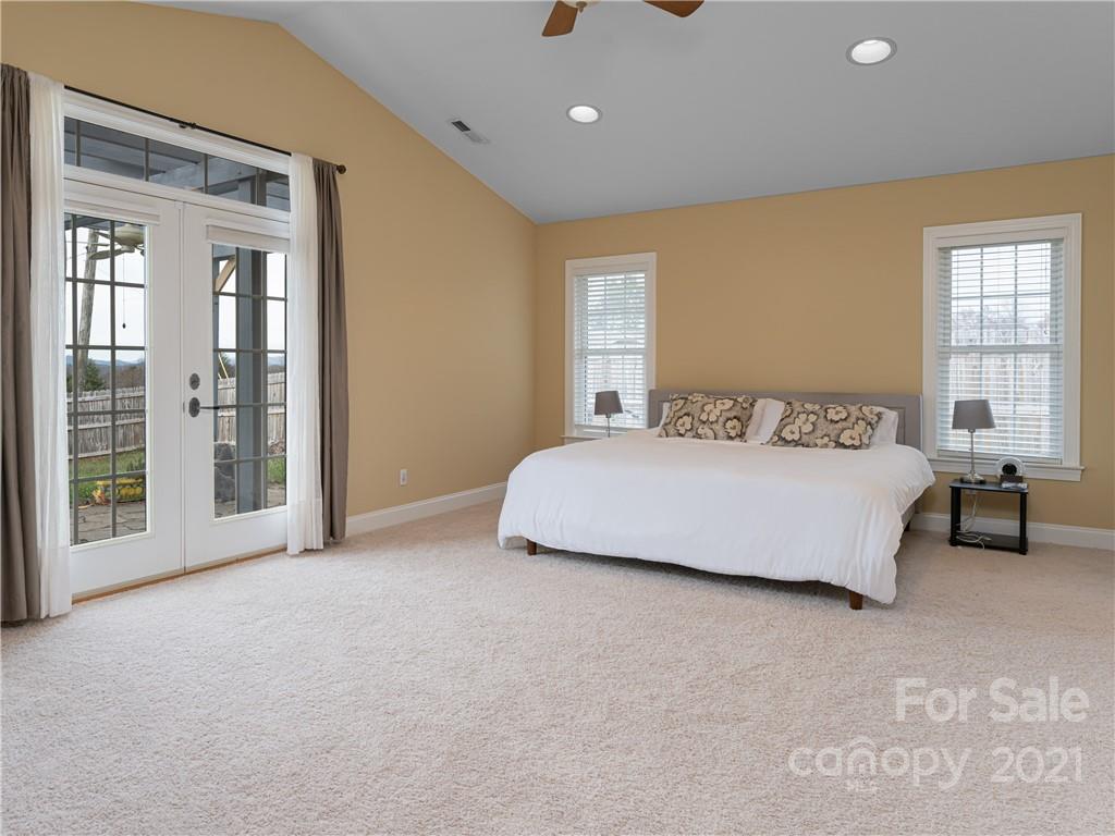 333 Gouges Branch Road Leicester, NC 28748 - Photo 24 of 48 a spacious bedroom with a bed and a couch