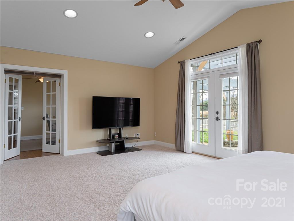 333 Gouges Branch Road Leicester, NC 28748 - Photo 25 of 48 a bedroom with a bed and a flat screen tv