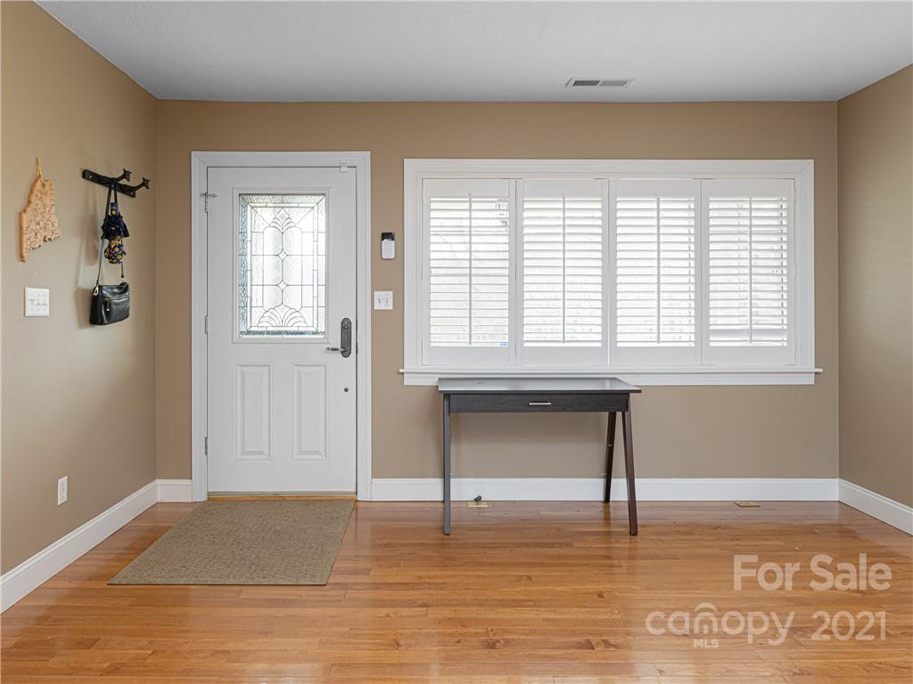 333 Gouges Branch Road Leicester, NC 28748 - Photo 4 of 48 a view of an empty room with window and wooden floor