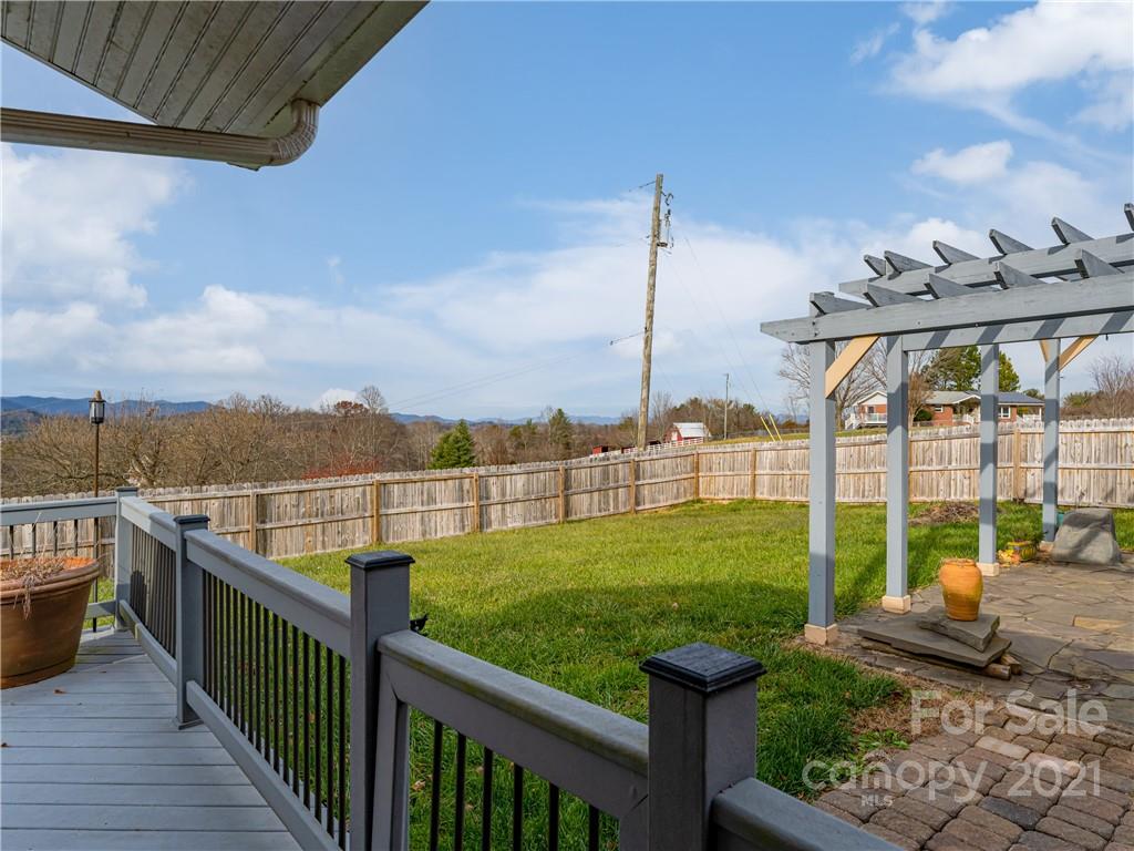 333 Gouges Branch Road Leicester, NC 28748 - Photo 40 of 48 a view of a balcony with floor to ceiling windows with wooden fence