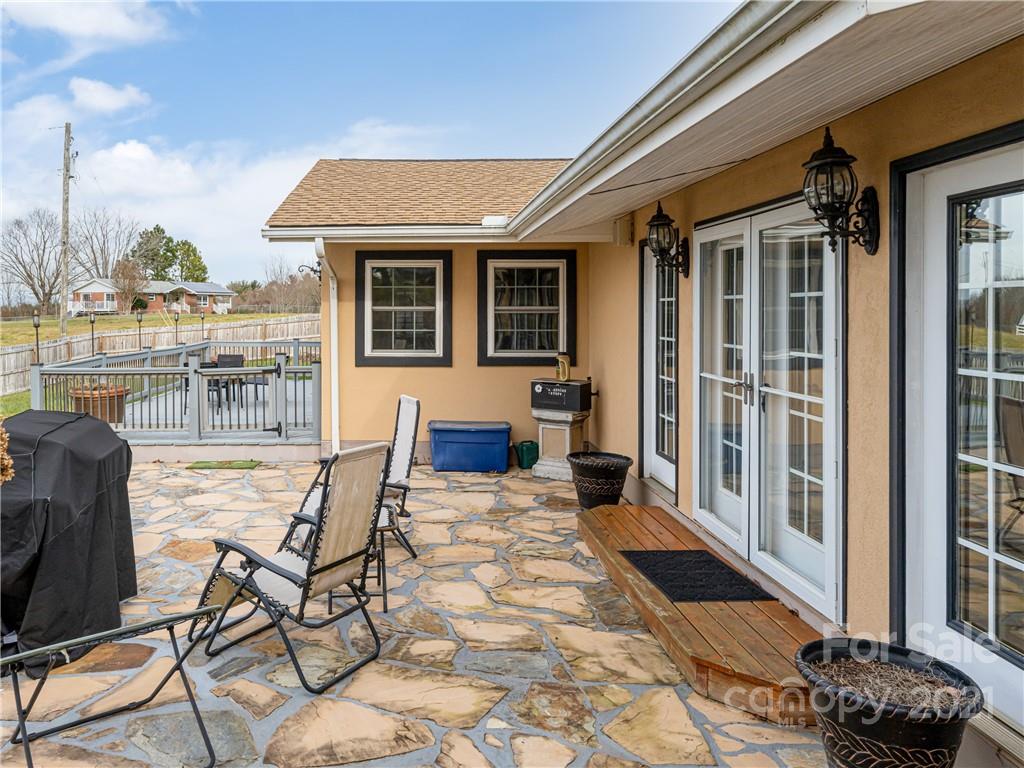333 Gouges Branch Road Leicester, NC 28748 - Photo 41 of 48 a view of a patio with table and chairs with wooden floor and fence