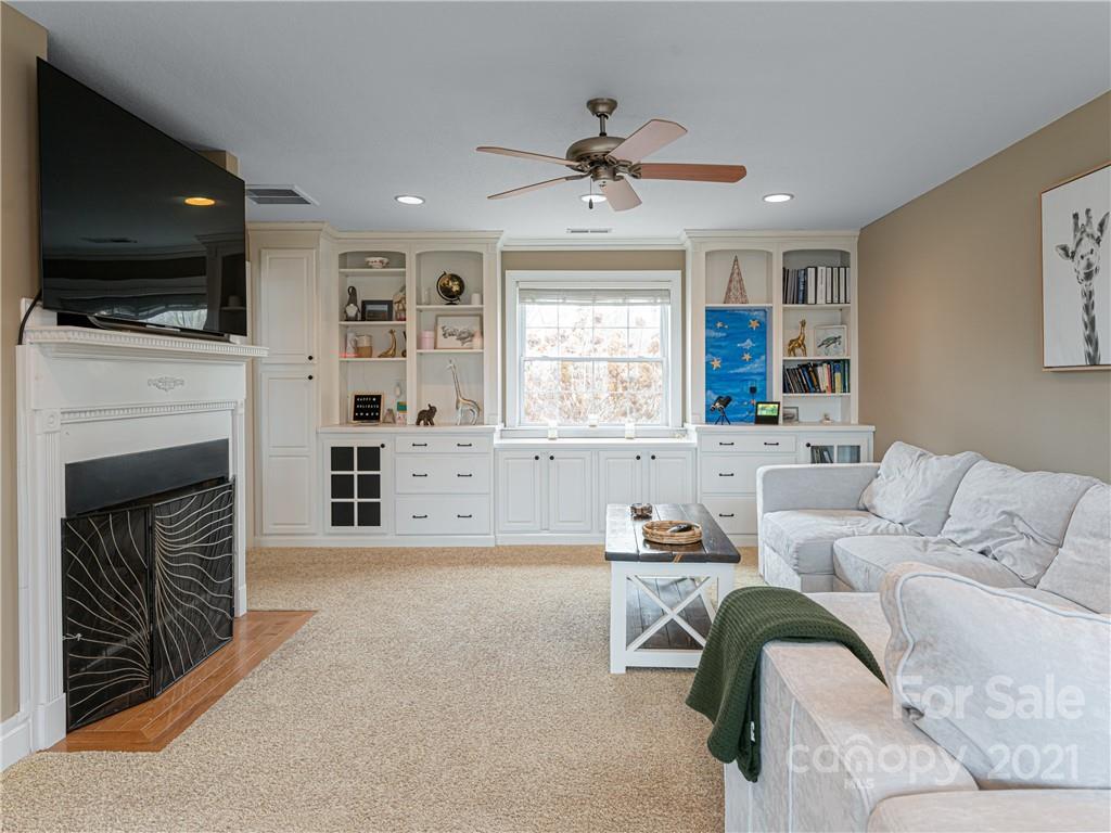 333 Gouges Branch Road Leicester, NC 28748 - Photo 10 of 48 a living room with furniture a fireplace and a flat screen tv