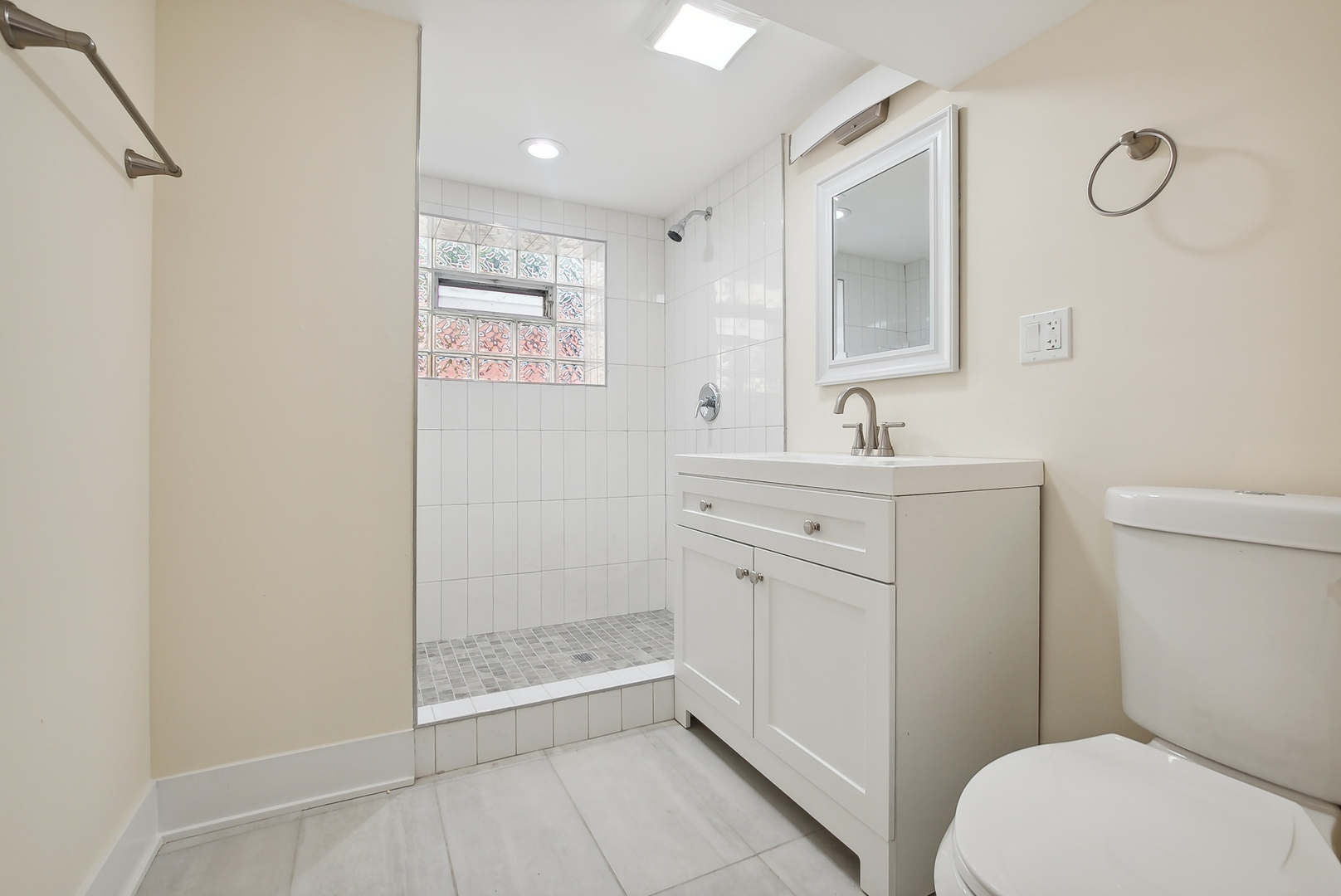 8325 South Perry Avenue Chicago, IL 60620 - Photo 13 of 15 a bathroom with a sink a toilet a mirror and shower