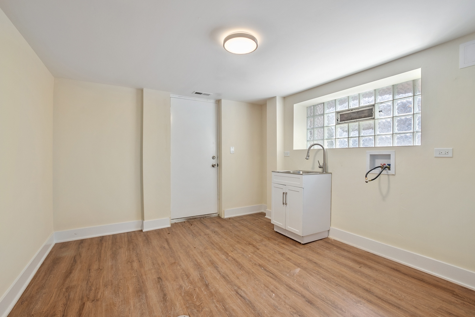 8325 South Perry Avenue Chicago, IL 60620 - Photo 14 of 15 a view of a room with wooden floor and sink