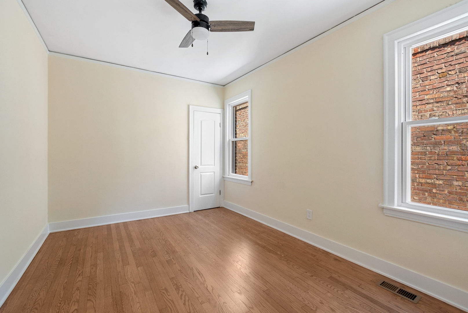 8325 South Perry Avenue Chicago, IL 60620 - Photo 6 of 15 a view of an empty room with wooden floor and a window