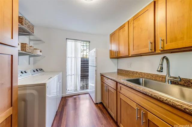 a kitchen with a sink a refrigerator and cabinets