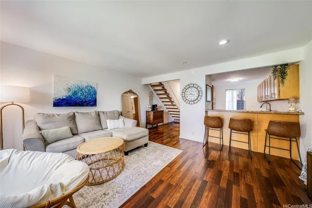 a living room with furniture and wooden floor