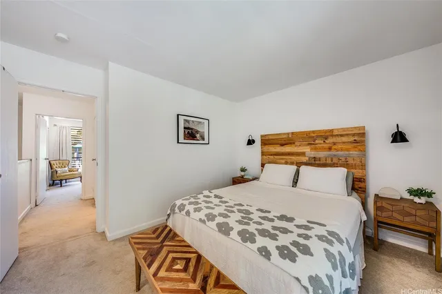 a bedroom with a large bed and a chandelier