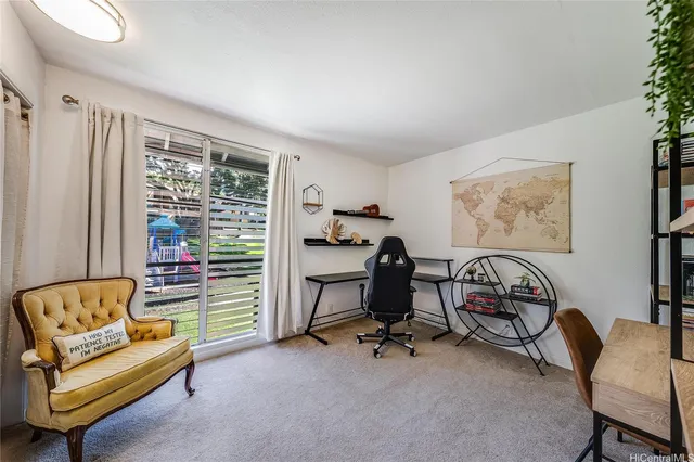 a view of a livingroom with workspace and a couch