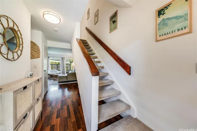 a view of entryway with wooden floor and stairs