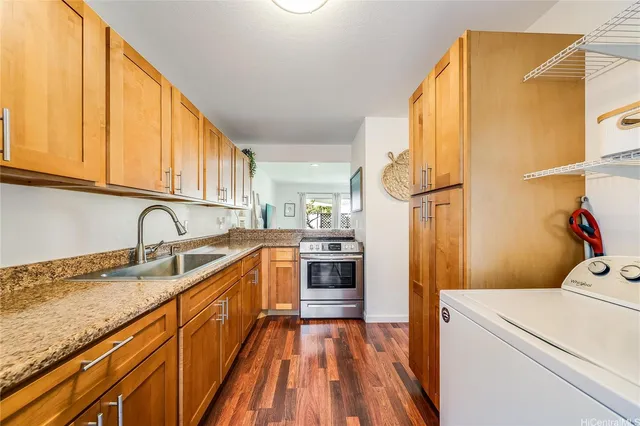 a kitchen with a sink a refrigerator and cabinets