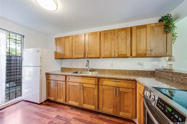 a kitchen with a sink cabinets and appliances