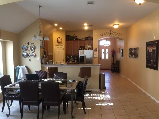 a view of a a dining room with furniture window and wooden floor