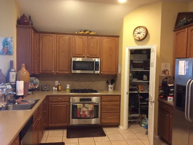 a kitchen with stainless steel appliances granite countertop a stove and a refrigerator