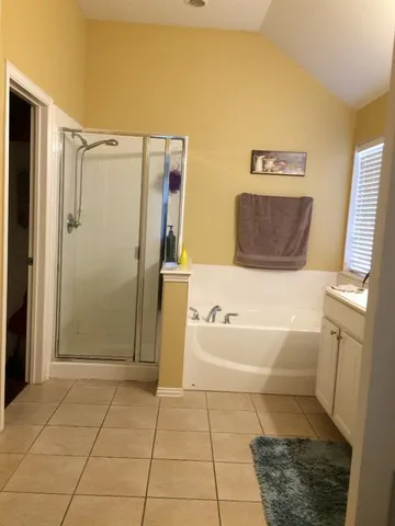 a bathroom with a bathtub and a shower