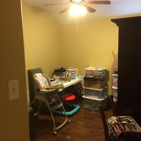 a room with a chair and wooden floor