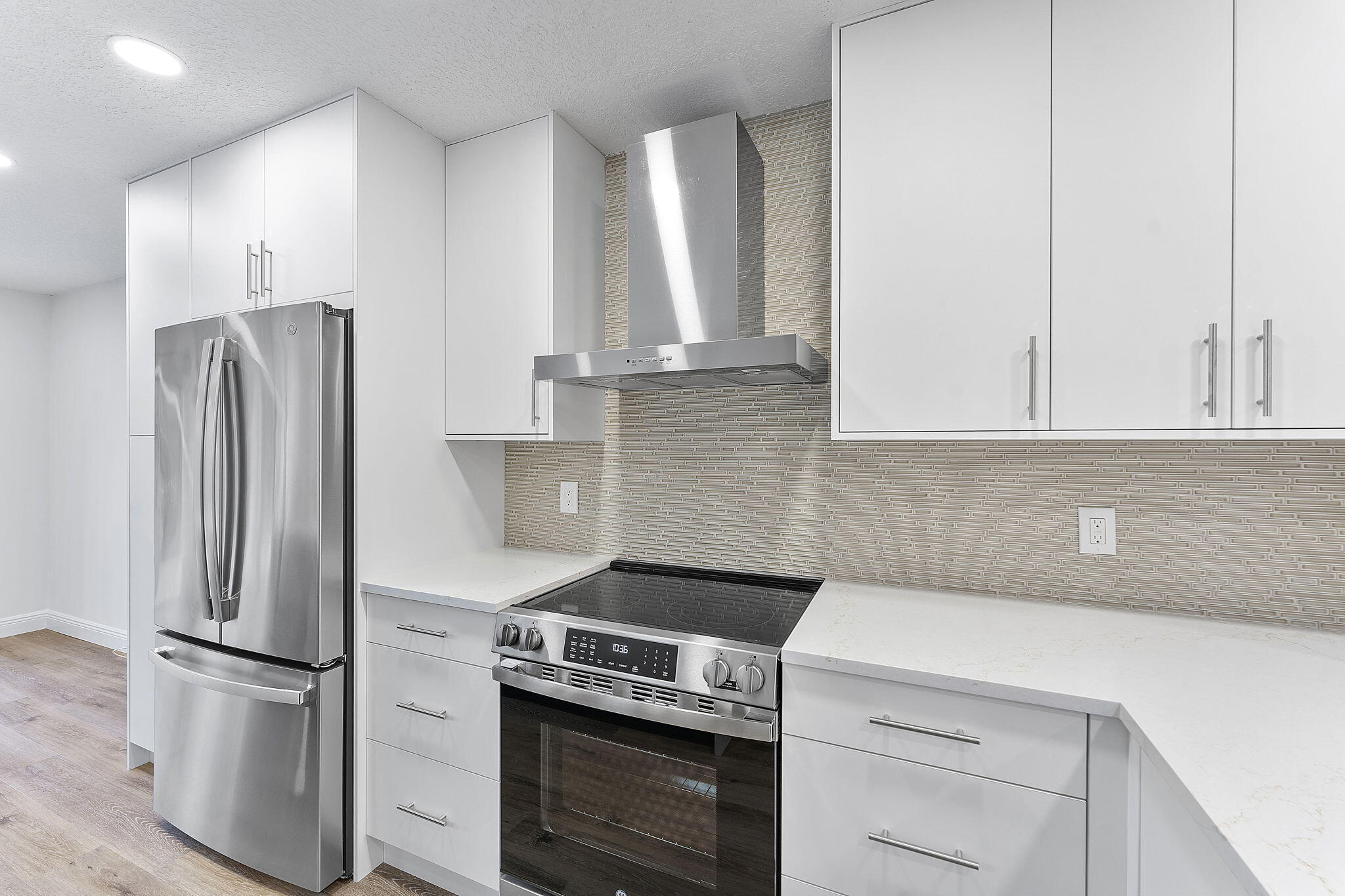 9180 Pine Springs Drive Boca Raton, FL 33428 - Photo 12 of 29 a kitchen with appliances a refrigerator and cabinets