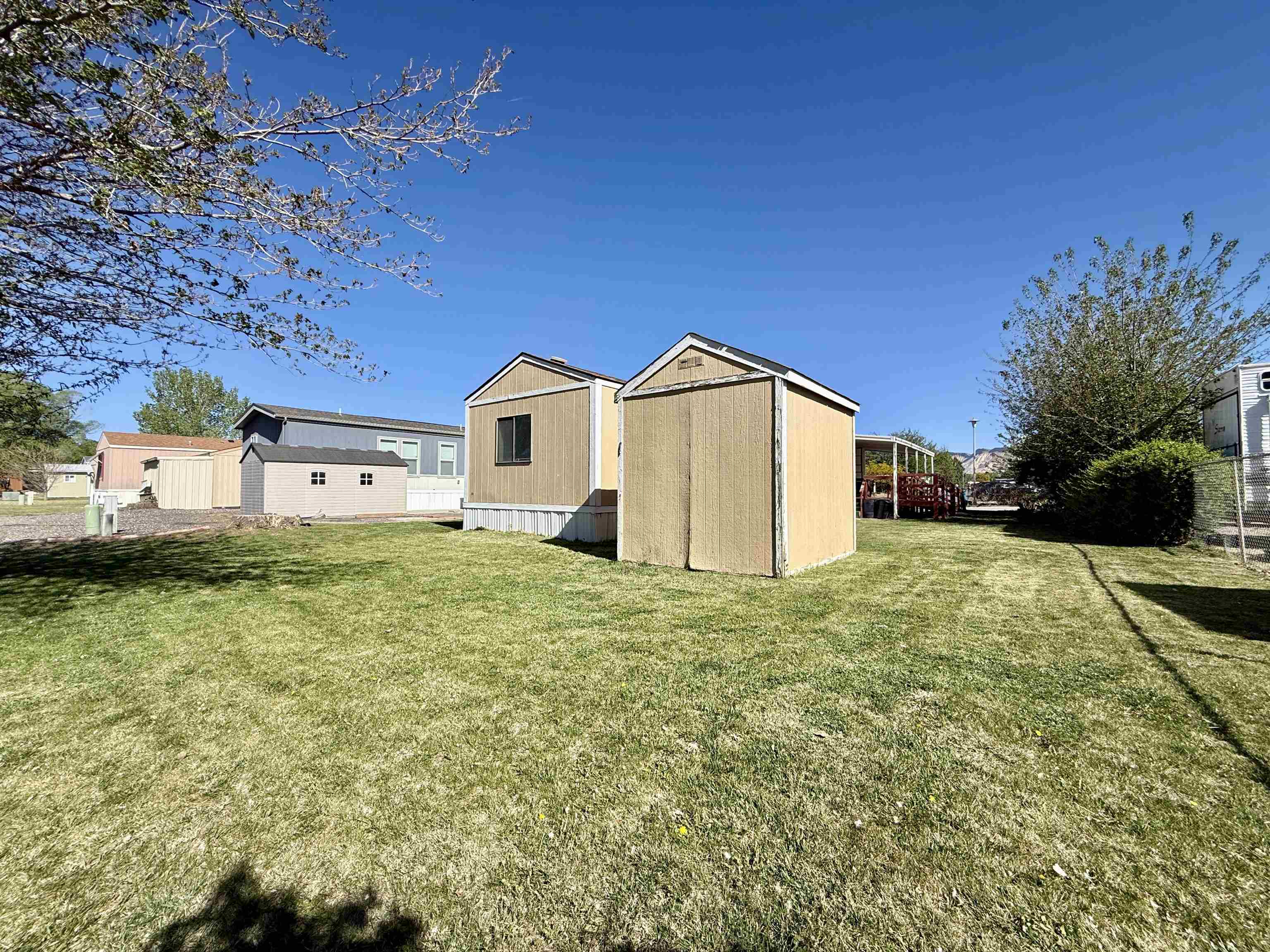 3251 E Road, Unit 33 Clifton, CO 81520 - Photo 25 of 28 a view of a house with a yard