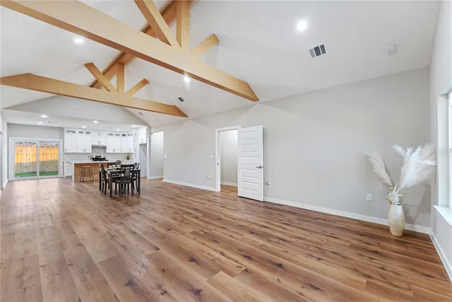 a view of a room with chairs and wooden floor
