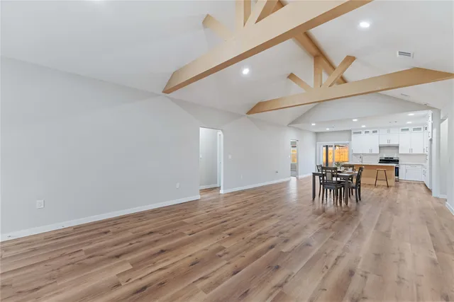 a view of a dining room with furniture and wooden floor