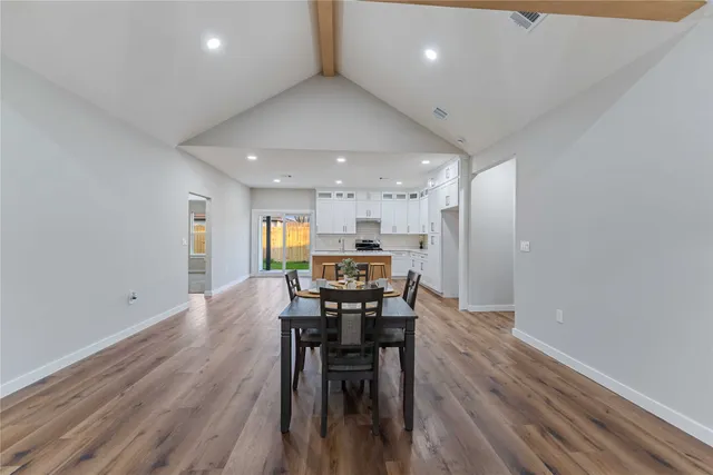 a view of a dining room with furniture and wooden floor