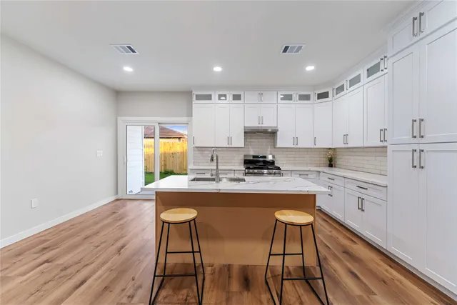 a view of kitchen with granite countertop cabinets table and chairs