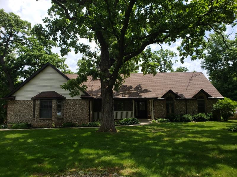 17347 Stimes Road Capron, IL 61012 - Photo 1 of 25 a front view of a house with a garden and yard