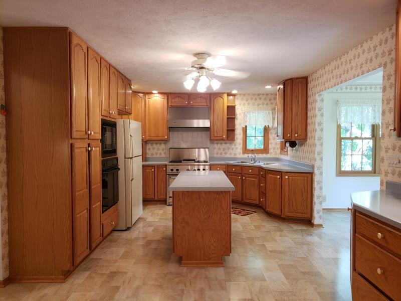 17347 Stimes Road Capron, IL 61012 - Photo 11 of 25 a large kitchen with a stove a refrigerator and a stove
