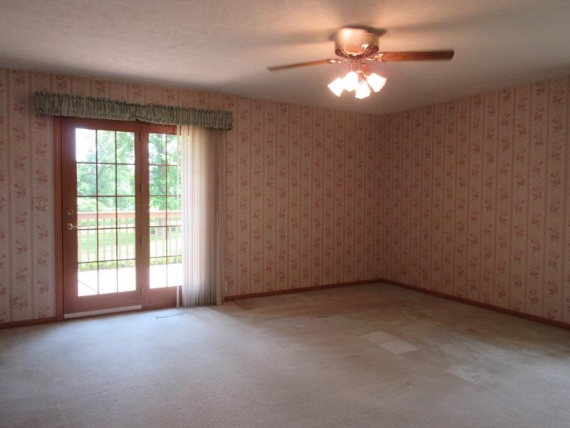 17347 Stimes Road Capron, IL 61012 - Photo 23 of 25 en empty room with windows and chandelier fan