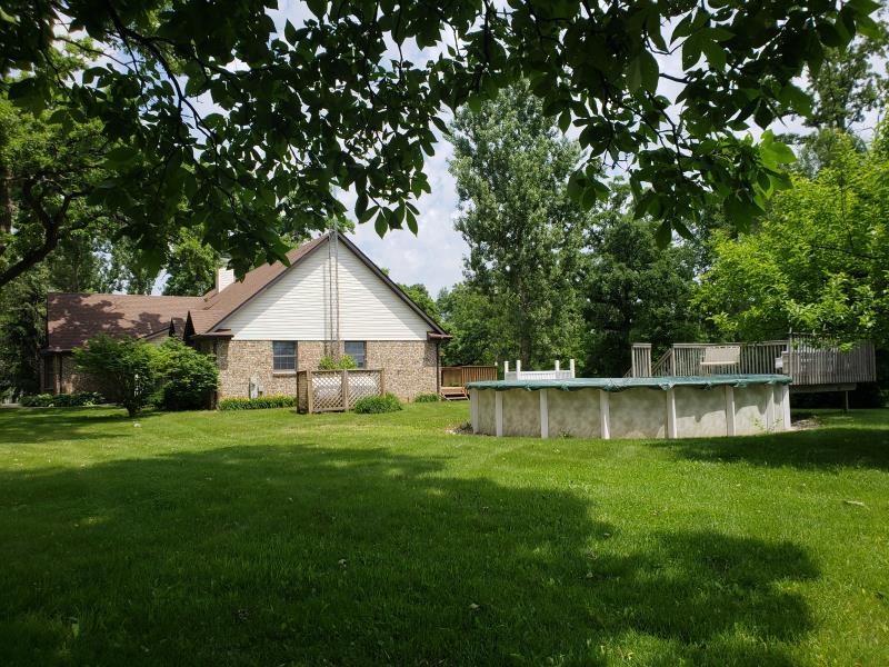 17347 Stimes Road Capron, IL 61012 - Photo 4 of 25 a view of a house with a yard and a large tree