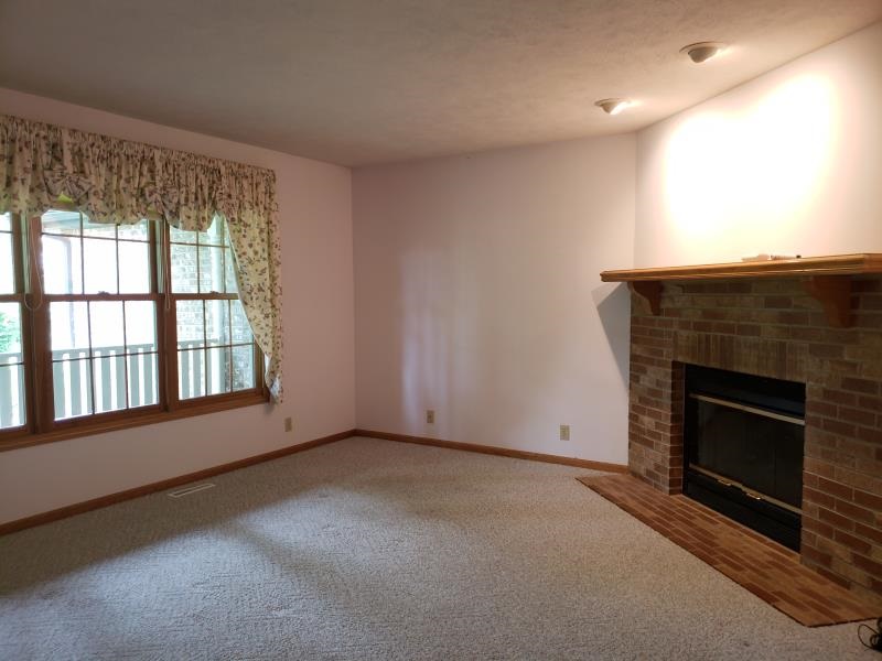 17347 Stimes Road Capron, IL 61012 - Photo 5 of 25 an empty room with a fireplace
